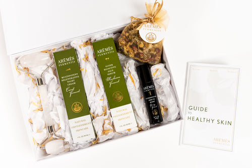 Gift set with skincare products and a guide on a white background