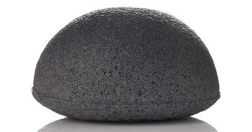 Black konjac sponge on a white background